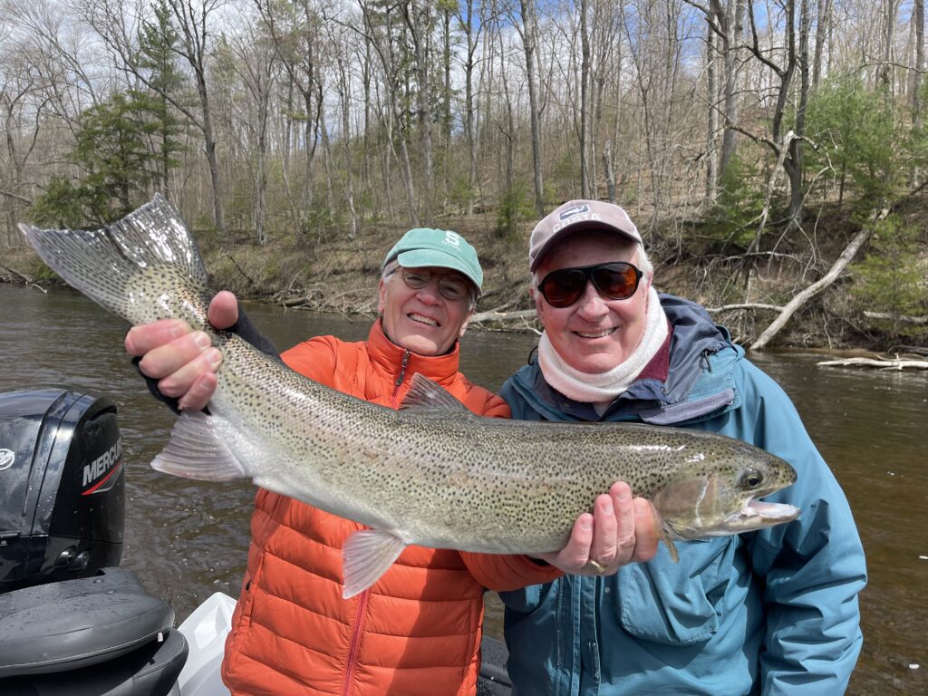 Alan holds a great Muskegon river steelhead while long time friend and Muskegon river veteran Jack, looks on.